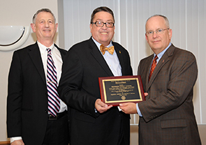 Dr. Stanley Leasure receiving the Master Online Course Recognition Award with Dr. Frank Einhellig and President Clif Smart