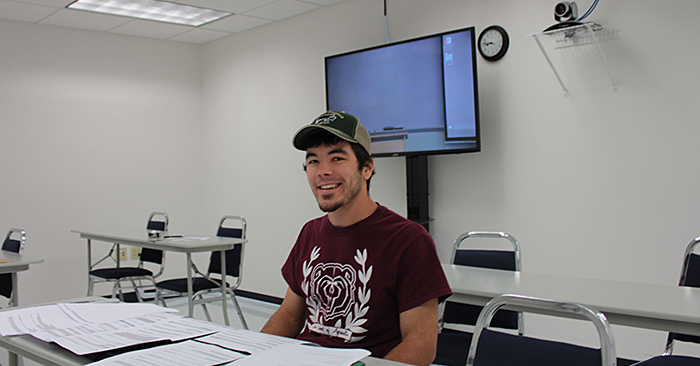 Male MSU student sitting in the interactive video classroom in Neosho. 