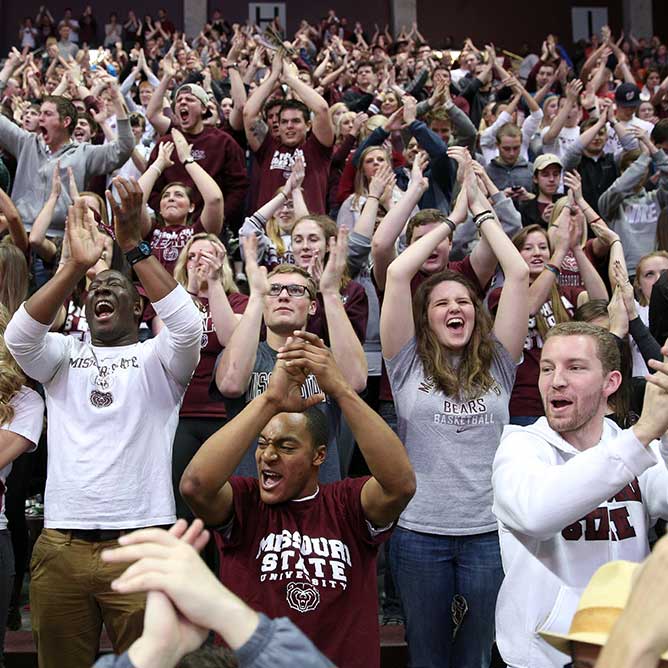 A crowd of students cheering at a Missouri State event.
