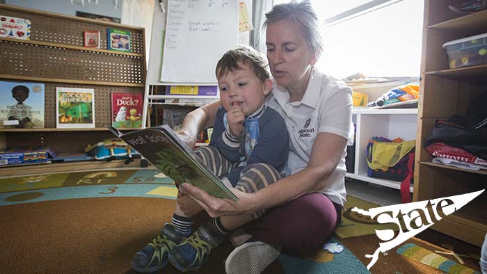 infant being read to